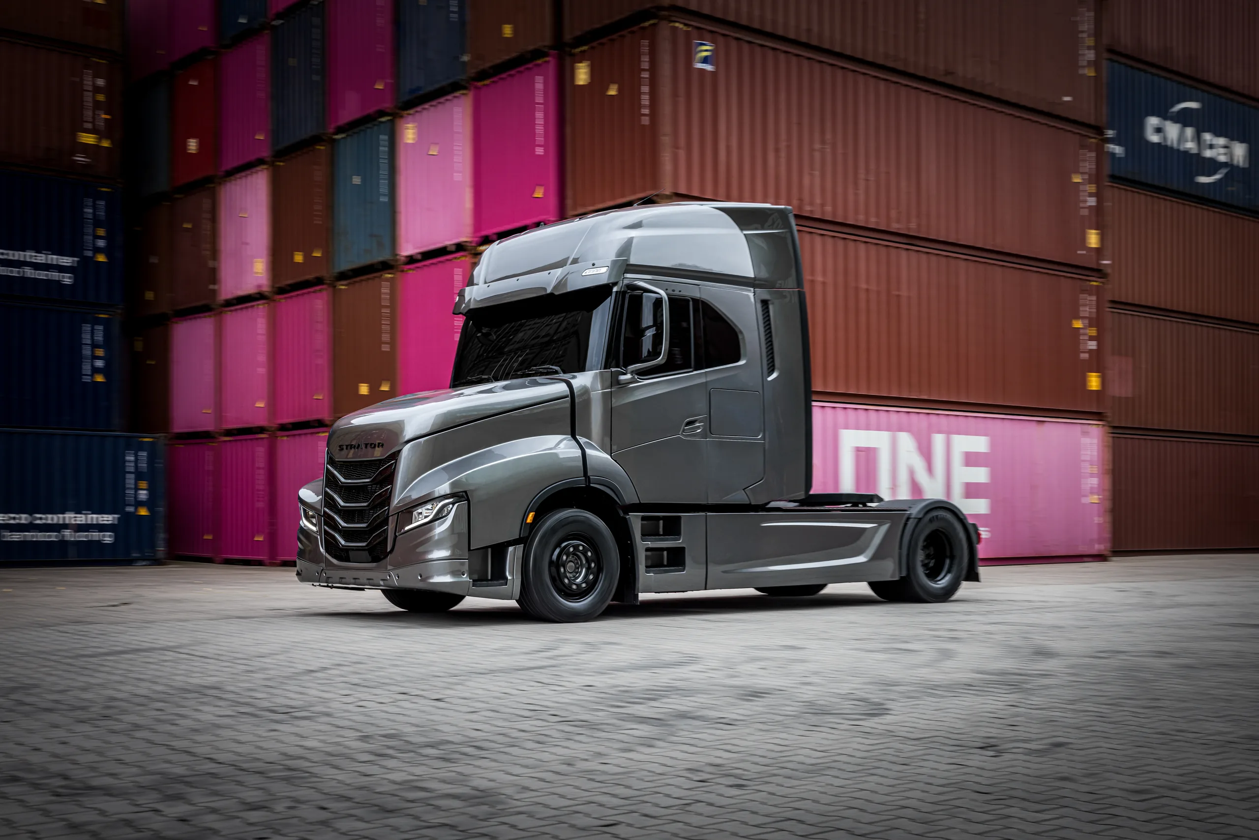 STRATOR show truck at a container terminal, three-quarter front view